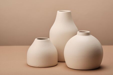 Different Collection of Handmade Bathroom Cups Standing on Brown Table Copyspace. Eco Clean Fashion Stylish Blue and White Mugs for Hygiene Bathroom Accessories Toothbrush and Soapの写真素材