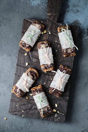Cake with Chocolate is Good Present for Rawfoodist. Piece of Yummy Coffee Tart on Wooden Board. Healthy Vegan Food Sweet Dessert Concept. Practice of Eating Uncooked Product. Top View Grey Backgroundの写真素材