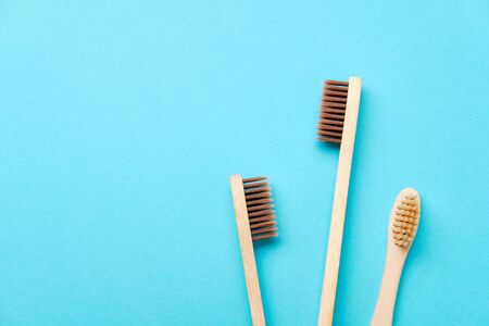 Wooden Toothbrush Isolated on Blue Background Copy Space Flat Lay. Tooth Brushes Scattered on Table....