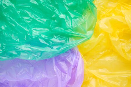 Close up Texture of a multicolor Plastic garbage Bag. Green Polyethylene Film. Texture of cellophane