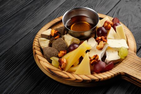 Assorted cheeses with honey and nutsの写真素材