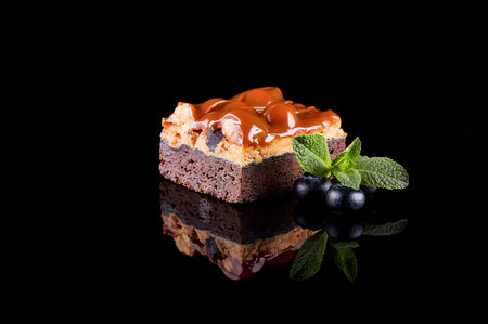 Sweet chocolate and nut dessert on a black background. Mirror reflection.の写真素材