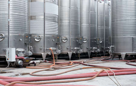 Modern stainless steel barrels for wine fermentation at a winery. Wine industry. Front view.の写真素材