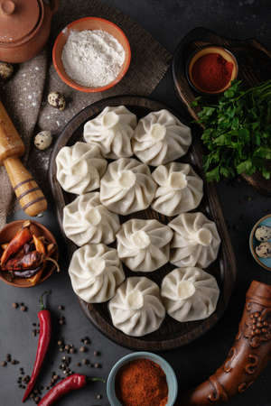 National Georgian cuisine. Khinkali with meat. Khinkali on a dark wooden board close-up. Macro shooting.の写真素材
