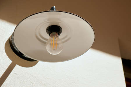 Old street lamp in the form of a plate with a modern LED lamp. Bottom view.