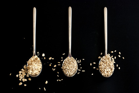 three different grains in three spoonsの写真素材
