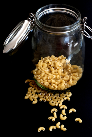 yellow dry noodles in a glass containerの写真素材