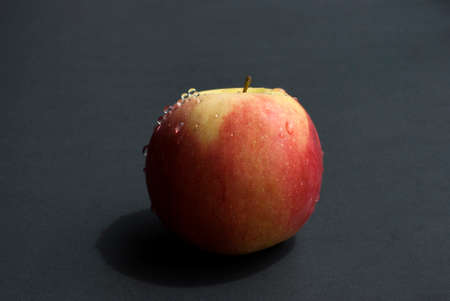 Ripped apple in a black backgroundの写真素材