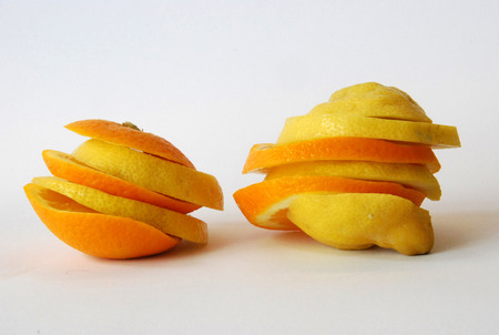 Fresh tasty colorful closeup orange and lemon in a white backgroundの写真素材