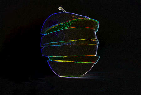 Amazing glowing orange, lemon and an apple in  black backgroundの写真素材