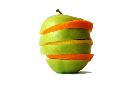 Fresh tasty colorful closeup orange, apple and lemon in a white backgroundの写真素材