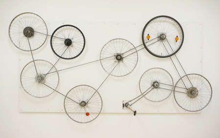 Bisycle wheels on the wall, personal art exibition, gallery, pedal, conected. The wheels are...