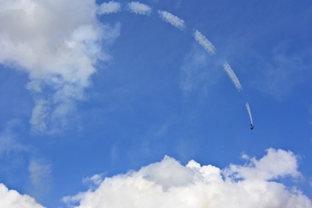 An acrobat airplane in the blue sky