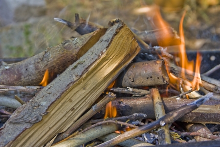 firing woods on a barbeque to cook meat on itの写真素材
