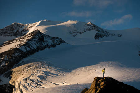 Reflexive climber alone in alpine enviroment under the Castor summit, near Quintino Sella, Italian Alps.の写真素材