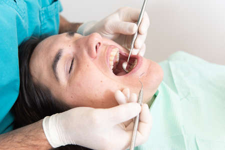Close up frame of a dentist making a basic check up to a patient.の写真素材