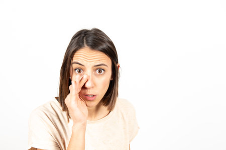 A serious latin woman telling a secret.の写真素材