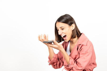 Excited hispanic woman telling a good new through her mobile phone.の写真素材
