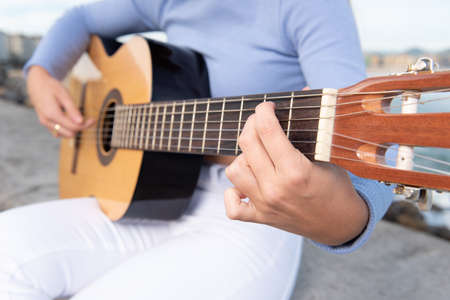 Closeup of teenage girl playing guitar.の写真素材
