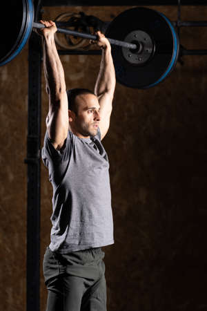 Fit man lifting a barbell