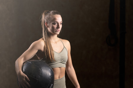 Portrait of concentrated fit woman holding medicine ball.の写真素材
