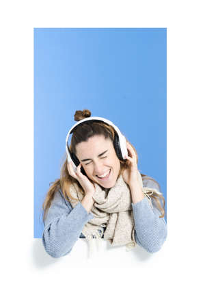 Woman enjoying listening to music on headphonesの写真素材