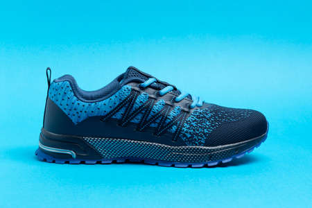Blue sport shoe with colorful background. Running and podiatry concept.の写真素材