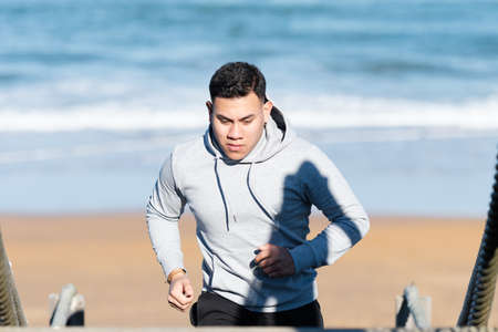 Half body of latin man training at the beach