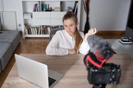 Teenager talking to camera at home. Creating content for social media. Homeschooling conceptの写真素材