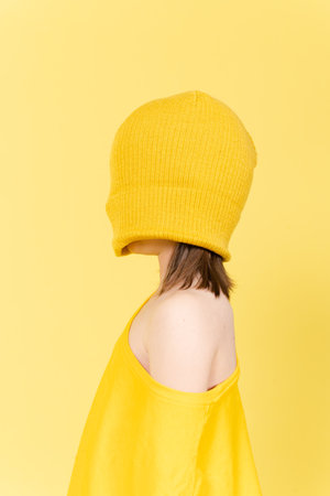 Abstract childhood problems concept. Blindfolded little girl wearing oversize t-shirt isolated on...