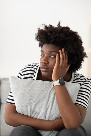 Young sad black woman hand on head suffering depression. Mental health conceptの写真素材