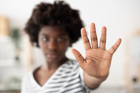 Closeup of african woman's hand making stop sign. Racism, equality and discrimination concept.の写真素材