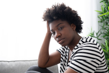 Sad serious black woman looking at camera. depression conceptの写真素材