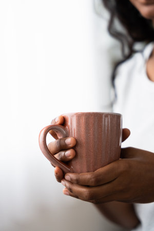 Unrecognisable black woman holding drink with copy space.の写真素材
