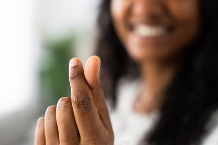Closeup of black womans fingers doing heart or love shape. Valentine conceptの写真素材