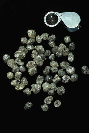 Natural Rough diamonds on black background sorted by size and shapes . High quality photoNaturalの写真素材