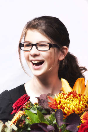 Smiling girl with bouquet of flowersの写真素材