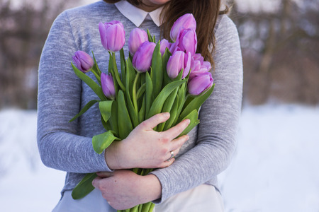 Bouquet of Purple Tulips in the hands of a girlの写真素材