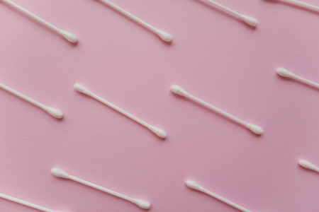 background of white cotton swabs on a pink backgroundの写真素材