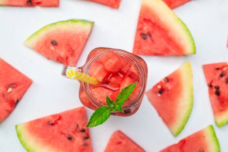 Summer watermelon drink. Summer Watermelon drink in glasses and slices of watermelon style flat lay...