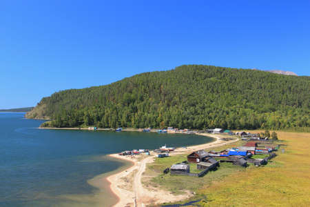 the coast of Lake Baikal, the settlement at the foot of the mountainの写真素材