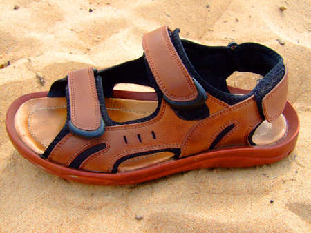 Photo of the summer open footwear on sand.の写真素材