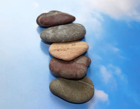 Stones for spa procedures on a background of the blue sky.の写真素材