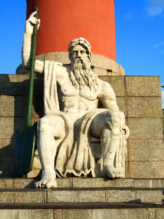Photo of a statue of the master of water on a throne.の写真素材