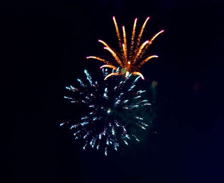 Splashes in colourful fireworks in the night sky.