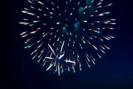 Splashes in colourful fireworks in the night sky.の写真素材