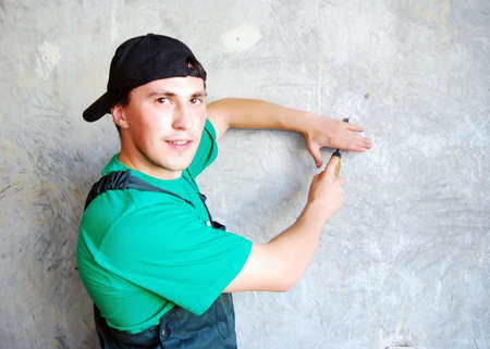 Muscular young man in a builder uniform.の写真素材