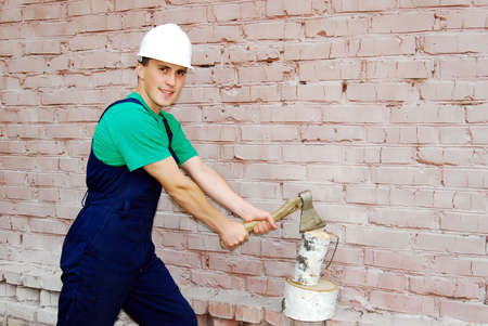 Muscular young man in a builder uniform.