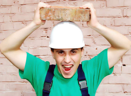 Muscular young man in a builder uniform.の写真素材