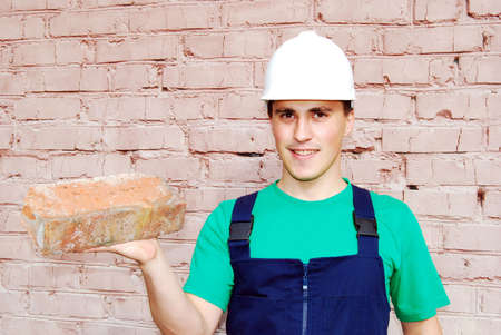 Muscular young man in a builder uniform.の写真素材
